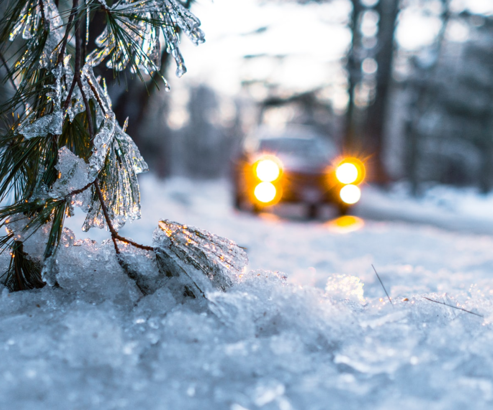 car in deep snow covered country road located in Canada
