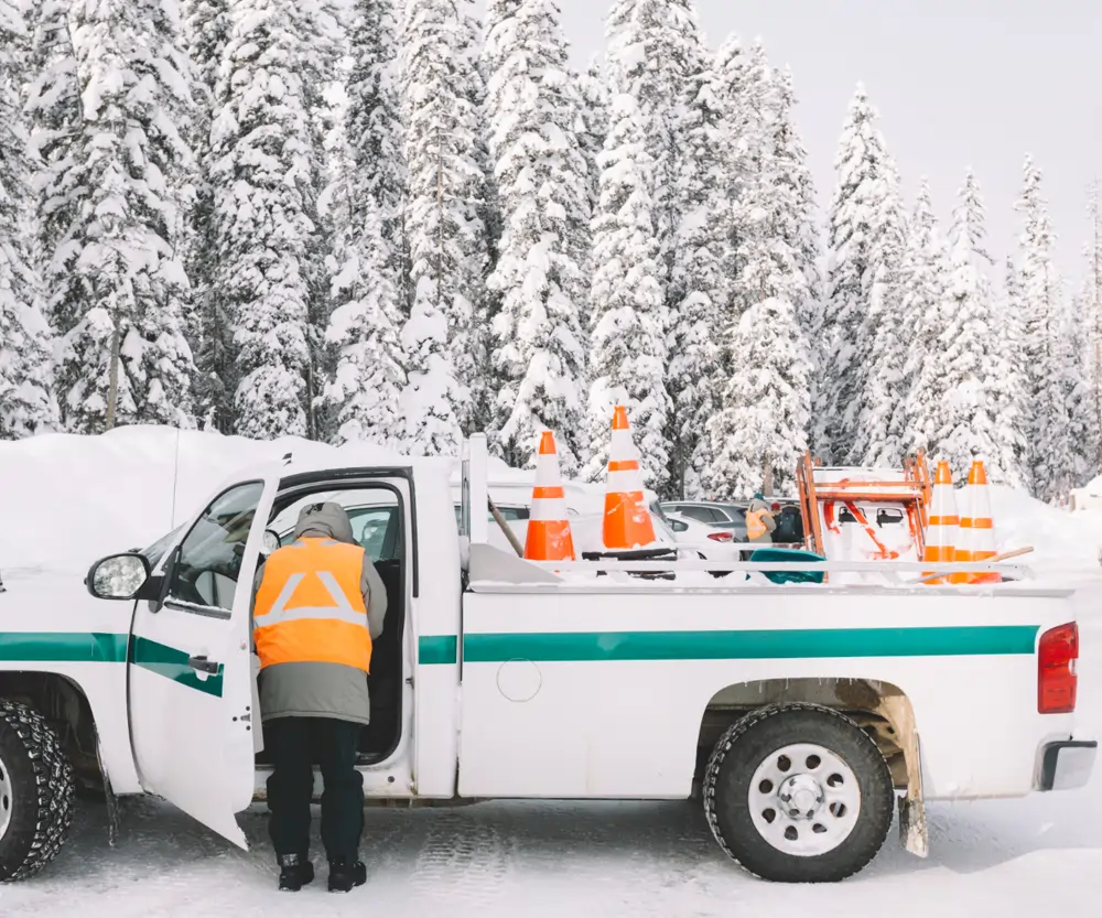 car in deep snow covered country road located in Canada